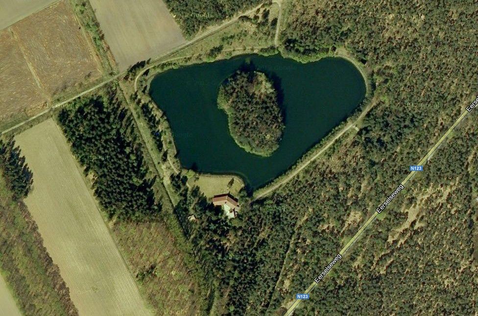 Seen from above lake with island and house.